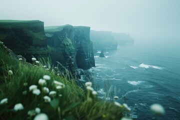 Aufkleber - A captivating view of the ocean and cliffs covered in a mystical fog. Perfect for adding a sense of mystery and tranquility to any project or design