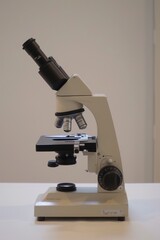 Aufkleber - A detailed close-up of a microscope placed on a table. Ideal for scientific research and laboratory-related projects