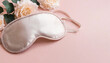 © ARVD73 - World sleep day concept.Banner with silk sleep mask on a soft pink background, layout, copy space, mockups for print or web design.