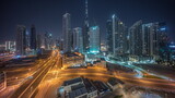 Fototapeta  - Aerial panoramic view of Dubai Downtown skyline with many towers all night timelapse.