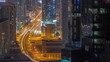 Aerial view from above to a busy road junction in Dubai all night timelapse.