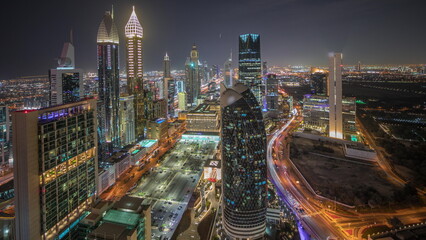 Wall Mural - Panorama showing skyline view of the high-rise buildings on Sheikh Zayed Road in Dubai aerial night timelapse, UAE.