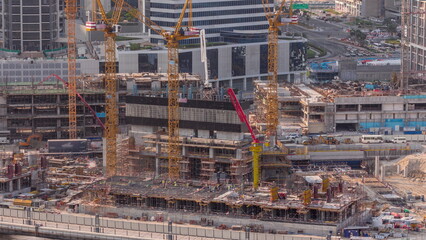 Wall Mural - Large construction site with many working cranes timelapse.