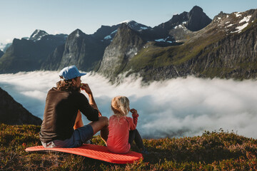 Wall Mural - family picnic father and daughter eating snacks in mountains travel vacations camping outdoor dad wi