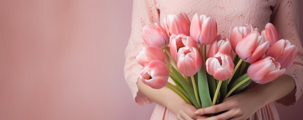 Wall Mural - Woman in a pink dress, bunch of spring tulip flowers in hand, on pastel background