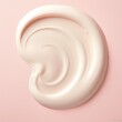 Close up view of a swirling soft pink cream texture, resembling a cosmetic lotion or highlighter swatch