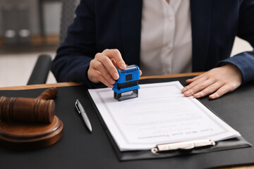 Canvas Print - Notary stamping document at table in office, closeup