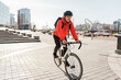 © muse studio - Urban cyclist in bright attire riding on city streets, blending commuting with fitness.