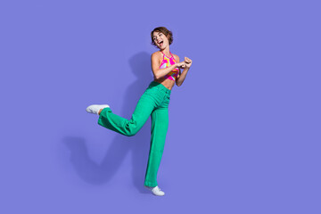 Poster - Photo of glad optimistic lovely woman dressed trendy clothes have fun chill look empty space isolated on purple color background