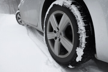 Wall Mural - Car with winter tires on snowy road outdoors, closeup. Space for text