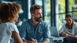 © Studio Nova - A bearded man in glasses enthusiastically discusses with colleagues during a team meeting at a vibrant office environment.