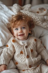 Sticker - In a joyful portrait, an excited baby girl in a knitted costume laughs with delight.