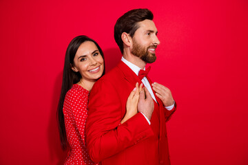 Poster - Profile portrait of two lovely partners embrace touch hands look empty space isolated on red color background