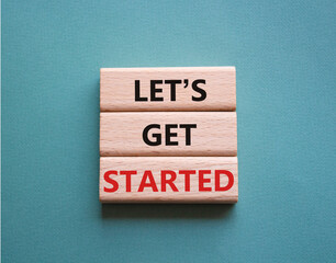 Wall Mural - lets get started symbol. concept words lets get started on wooden blocks. beautiful grey green backg