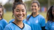 © JW Studio - Happy confident young female football soccer player together with her teammates outdoor on the field, concept of teenager soccer training, teamwork, female player, sports.