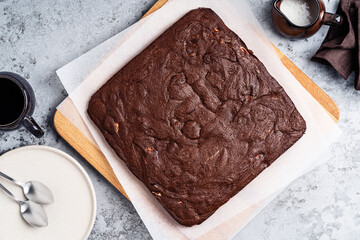 Wall Mural - Chocolate brownie cake with cream cheese on wooden board