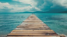 A Wooden Pier That Stretches Out To The Sea,seascape View With Mountain And Cloudy Sky For Travel In Holiday Relax Time As Summer