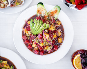 Mexican style tuna ceviche, with pineapple, avocado, onion, cucumber, cilantro and sauces, tropical style, fresh Mexican seafood, for Mexican tuna tostadas.
