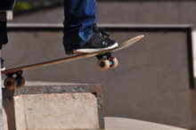 The Practice Of The Sport Of Skateboarding Carried Out On A Board, With Four Small Wheels And Two Axles
