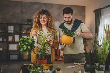 Couple man and woman wife and husband take care of plants at home