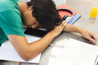 © Wavebreak Media - Exhausted teenage Asian boy sleeps on his desk at home, with copy space