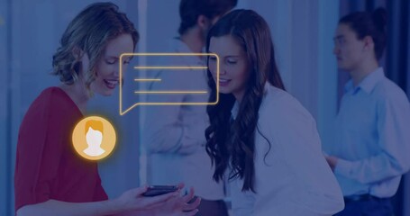 Poster - Animation of orange online chat icon over caucasian businesswomen with smartphone at casual office