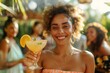 Attractive young female with a smile serving a cocktail in a tropical setting as the sun sets