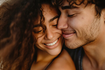 Close-up of romantic young boyfriend kissing smiling beautiful girlfriend