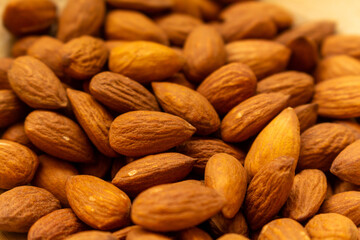 Heap of almonds, food background.