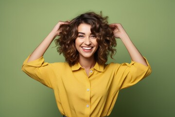 Wall Mural - Joyful woman in yellow blouse, vibrant background