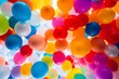 An abstract image of colorful balloons released into the sky
