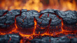 Closeup of a blazing fire showcasing the rough and ragged texture of the burning wood beneath the flames.