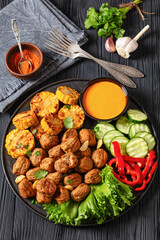 Canvas Print - baked meatballs with vegetables and sauce on plate