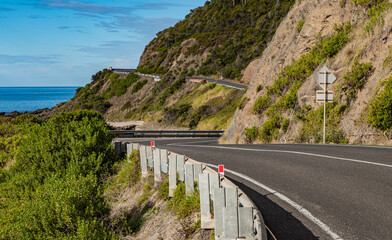 Wall Mural - The view of the curling road in the Great Ocean Road extending between the ocean and cliffs