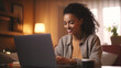 © EltaMax99 - Smiling young African woman shopping online. Laptop, credit card. Spending money concept. Surfing internet shopping online via laptop