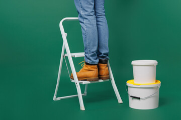 Poster - Close up cropped shot photo of employee laborer handyman man stand on stepladder near jar with paint isolated on plain green background. Instruments for renovation apartment room. Repair home concept.