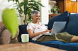 © Wavebreak Media - A mature biracial woman works on her laptop at home