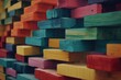 Spectrum of stacked multi-colored wooden blocks. Background or cover for something creative, diverse, expanding, rising or growing. Shallow depth of field.