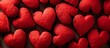 A pile of red hearts, resembling a stack of seedless fruit, sits on a table. The vibrant colors and organic shapes evoke feelings of love and warmth