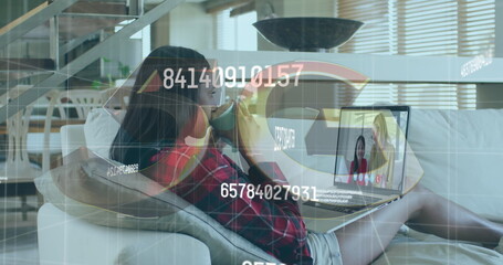 Poster - Image of numbers changing over woman using laptop on image call in background