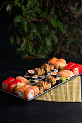 Wall Mural - assorted rolls. on a black wooden background.