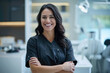 © boxstock production - Beautiful and confident Caucasian female dentist with a friendly smile standing inside a blurry modern clinic