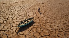 Aerial View Cracked Scorched Earth Soil Drought Desert Landscape With Small Fishing Boat