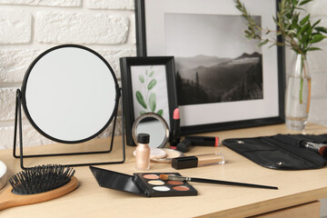 Poster - Mirror and makeup products on wooden dressing table, closeup