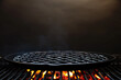 © Александр Довянский - black round grill grate with fire and smoke on black background, copy space