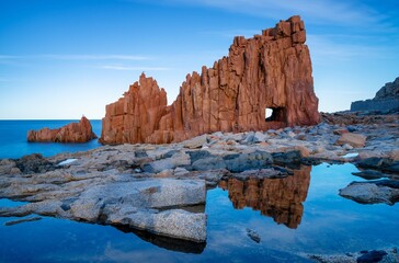 Poster - view of the red rocks of Arbatax with reflections in tidal pools in the foreground