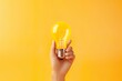 3d Hand hold light bulb idea thinking or solution business concept icon or symbol on yellow background  