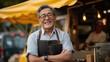 Joyful Asian Chef with Arms Crossed in Front of Food Stall