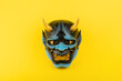 mask of the devil on yellow background