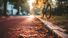 Bicycle Parked Next To Red Asphalt Cycling Lane, Bike Path In Autumn Park With Fallen Leaves At Sunset, Concept Of Eco-friendly Urban Transportation